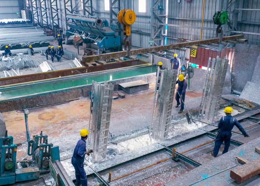 Workers working on a galvanisation process.