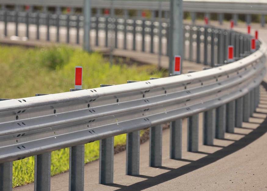 Image of beam barriers and rails on highway.