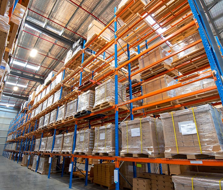 Heavy-duty pallet racks with boxes arranged.