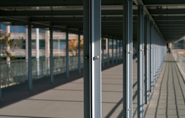 Metal beams, bolts, and clamping nuts used in railway industry.