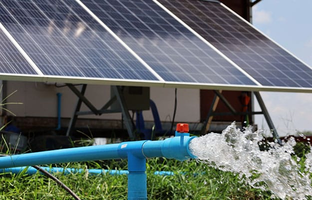 Close-up image of solar agricultural pumps in working with panels.