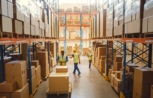A warehouse filled with shelves stocked with cardboard-boxed goods.