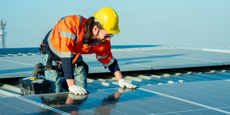 Technician inspecting the top of the solar mounting after installation